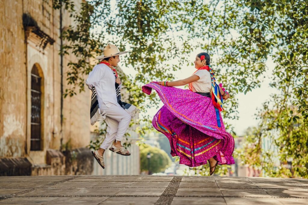 couple of dancers in traditional costumes in jump