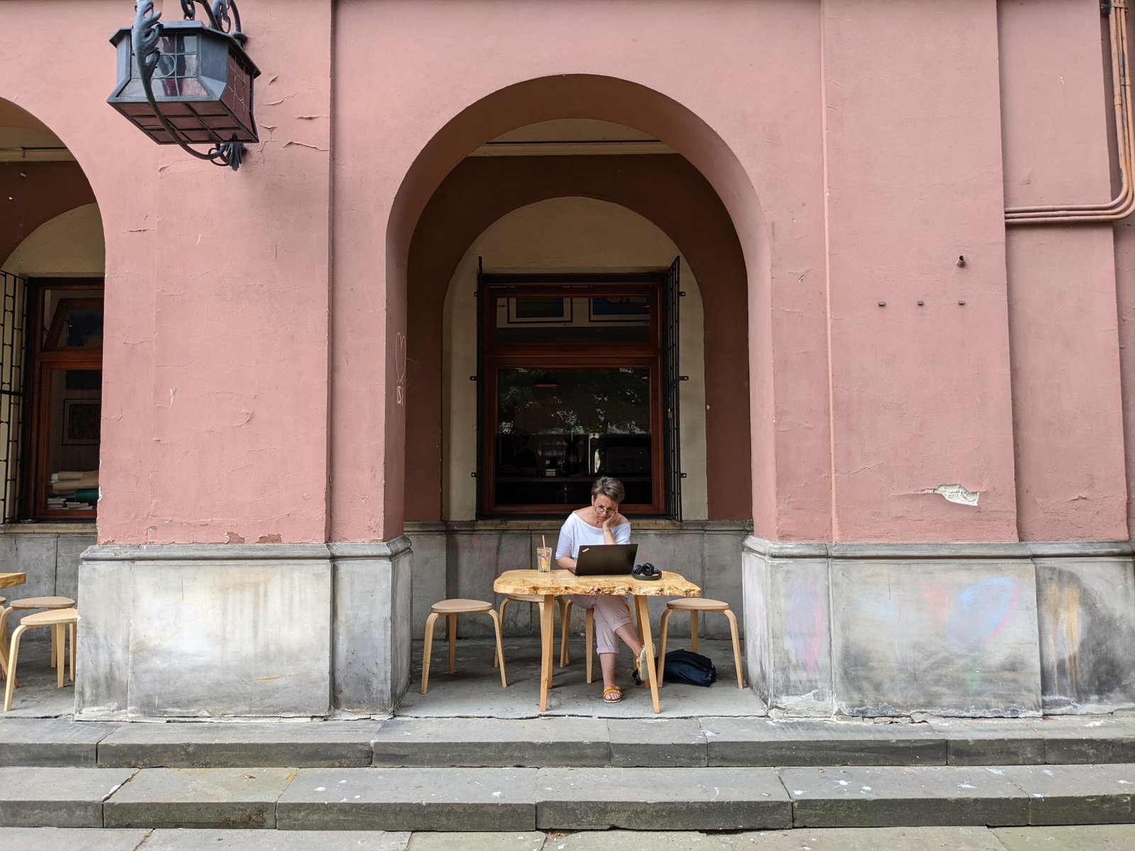 a woman using a laptop while sitting on a chair