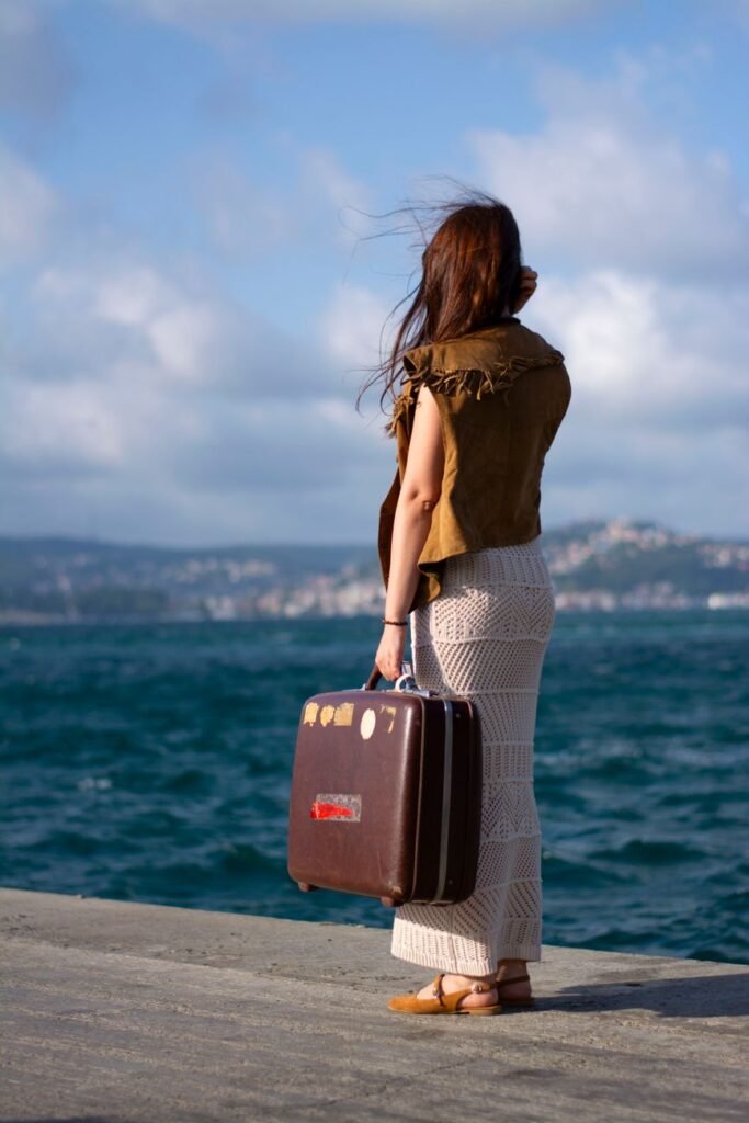 woman standing with a suitcase