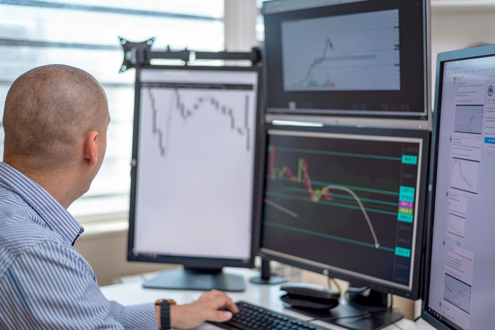 man in blue and white stripes shirt in front of black computer monitor