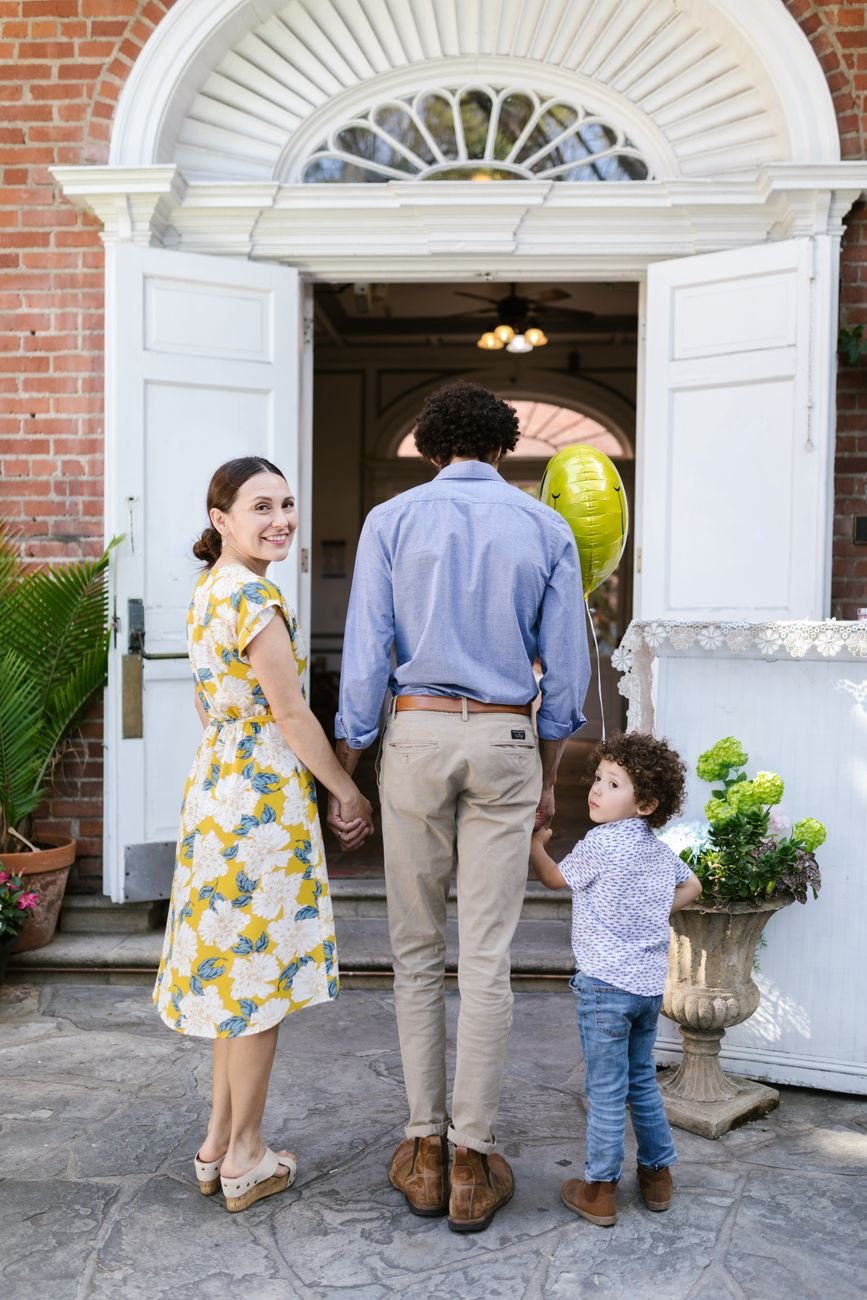 back view of a family holding hands