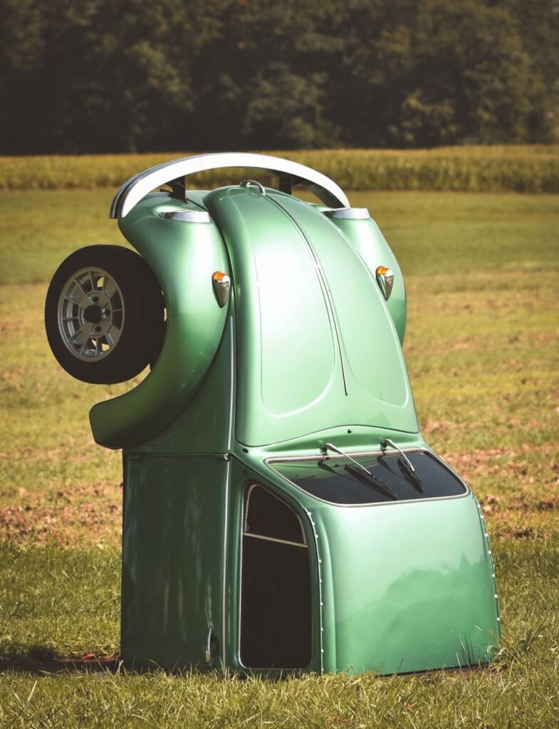 half of volkswagen beetle in grass